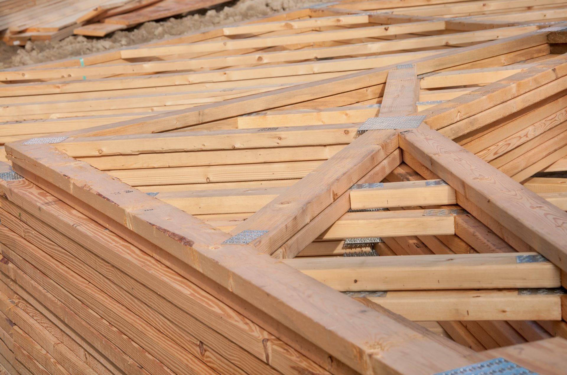 A stack of engineered roof trusses ready for delivery