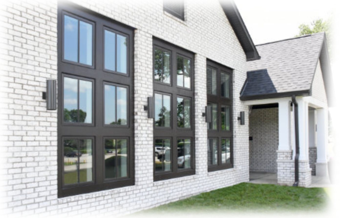 Black aluminum-clad windows on a white brick house